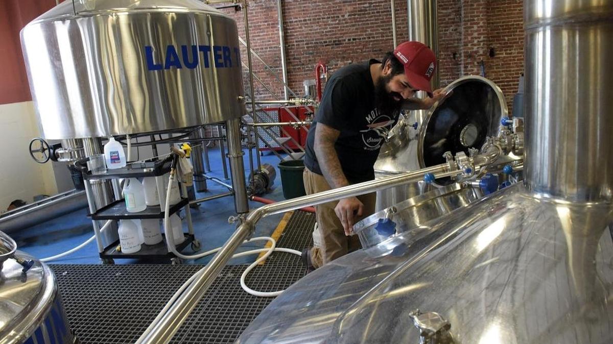 Jose Martinez checks the brewing process at Motorworks Brewing, the starting point for one of Taste Magazine’s historical and walking tours.