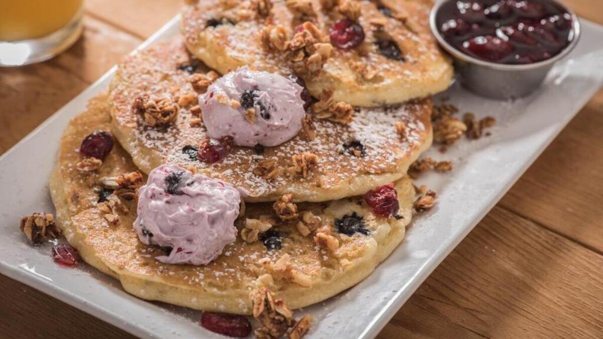 Quinoa pancakes topped with blueberry lemon butter and granola are a dish featured on First Watch’s Jump Start menu.