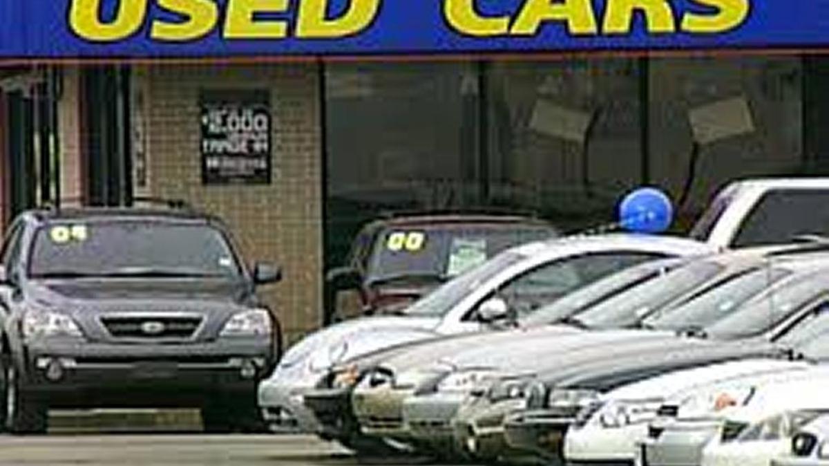 A used car dealer parking lot. 
