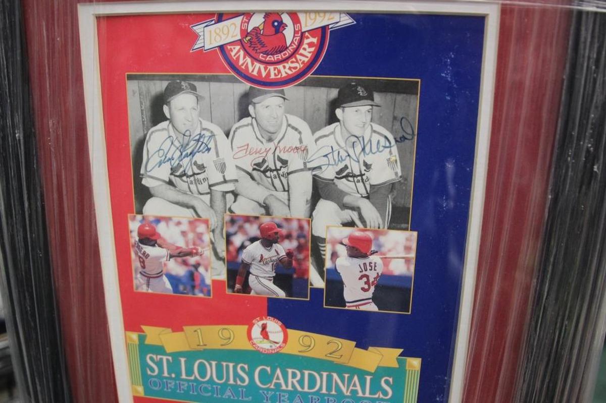 A 1992 Cardinals yearbook includes the autographs of Enos Slaughter, Stan Musial and Terry Moore. It’s one of the items for sale at D’s Cards & Memorabilia.