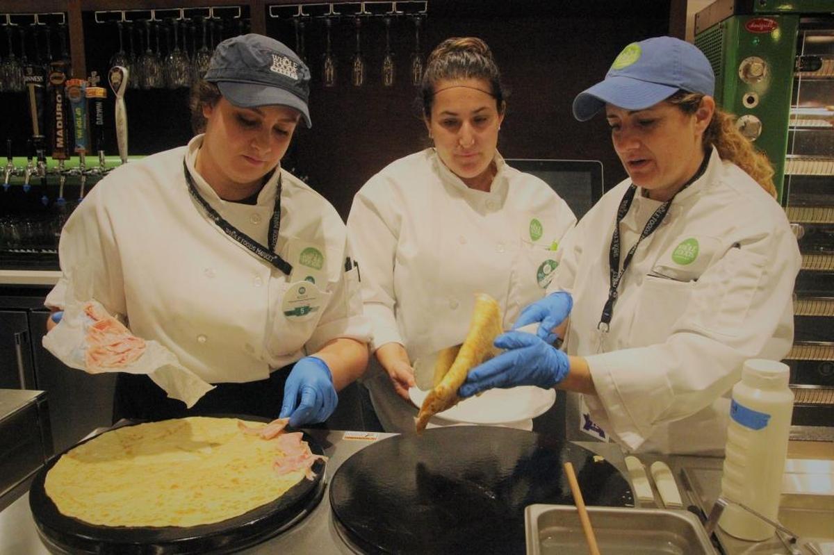 The culinary staff at Whole Foods Market cooks up French-inspired crepes this week during a tour. The 40,000-square-foot store at 5298 University Parkway opens on Wednesday.