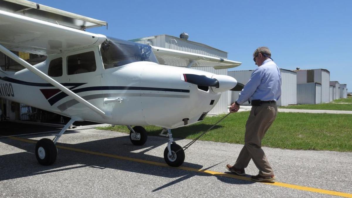 Jim Faix pulls his 1956 Cessna 172 out of his Port-A-Port hangar at SRQ International’s airfield. He and 26 other Port-A-Port hangar owners were notified in April that they must remove the buildings and vacate the airport by early 2018.