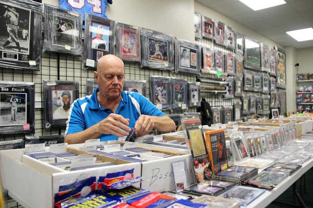 Paul Warner sorts through sports cards at D’s Cards & Memorabilia, 120 53rd Ave. W., Suite B2, Bradenton. The company opened its doors in Bradenton in February 2016.