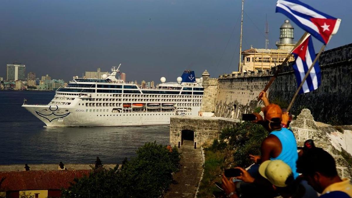 People waving Cuban flags greeted passengers on Carnival’s Adonia cruise as it neared Havana Harbor on May 2.