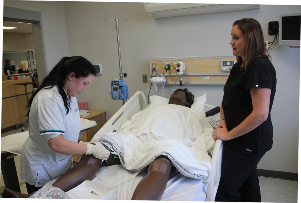 Jennifer Prutzman, left, is in her last term at State College of Florida, where she is in training to become a registered nurse. Working with her is Jaime Castoral, a clinical instructor.
