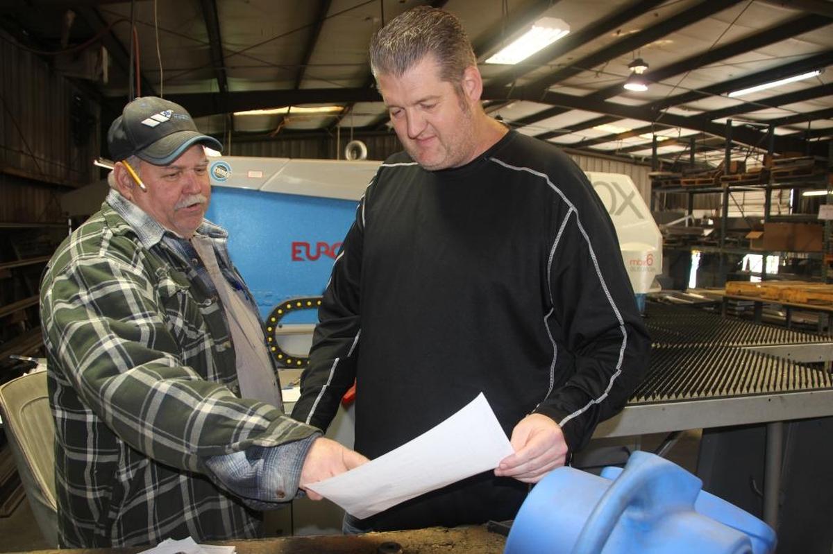 Donnie Gorse, shop foreman, left, talks about a project at Edmunds Metal Works with Matt Edmunds. Edmunds is the second generation of his family to lead the company.