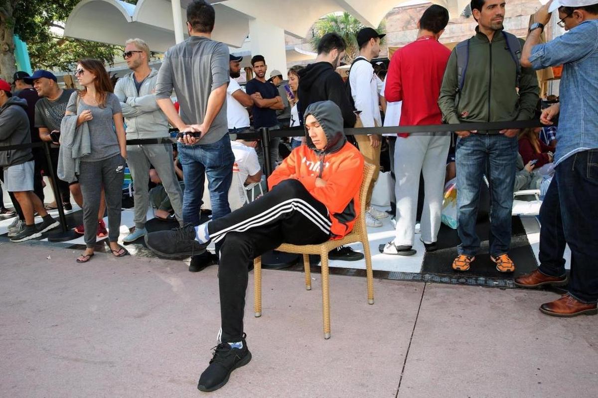 Mathew Sierra, 19, takes a nap after waiting in line at an Apple Store in Miami Beach to buy the new Apple iPhone X last month.