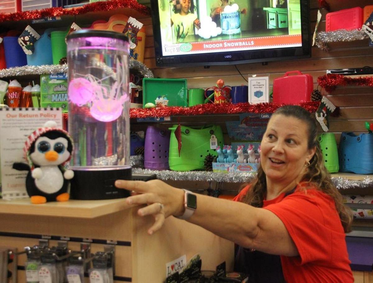 Pam Stolz, owner of Learning Experience Toys, says the floating, color-changing jellyfish in her store will put a smile on anyone’s face.