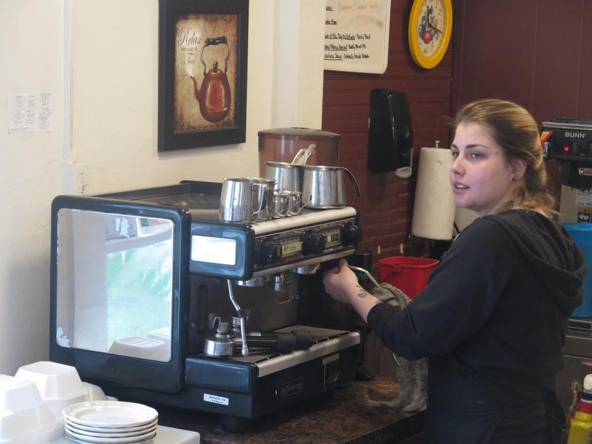 Lauren Solis prepares coffee during one of her final shifts as a barista at Latte Luna. Solis said she’s been at the shop for three years and during that time, her coworkers began to feel like family.