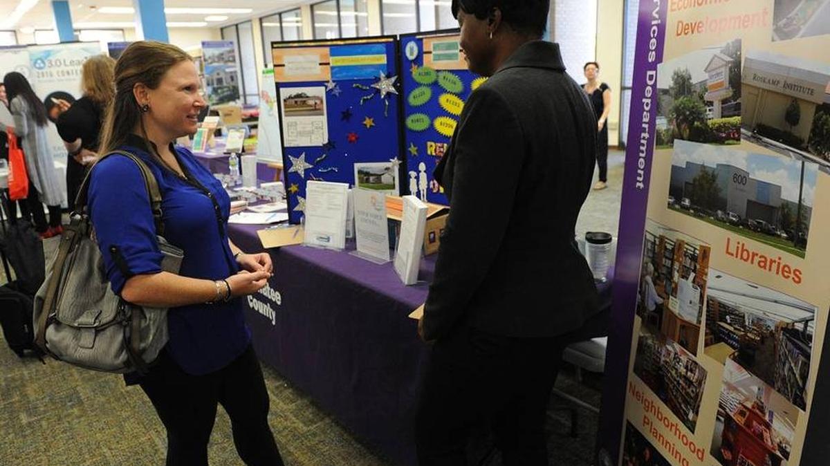 Shawn Shields talks with Shelonda Marie, with Manatee County Government Neighborhood Services, during a past small business expo at the Manatee County Central Library.