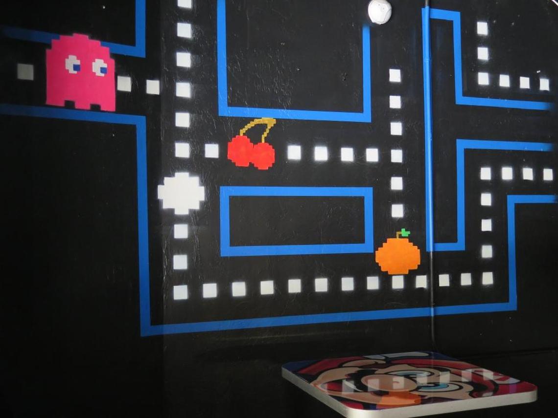 Artwork by local artist Matt McAllister makes for a colorful backdrop at Play Arcade and Bar, 436 12th St. W.