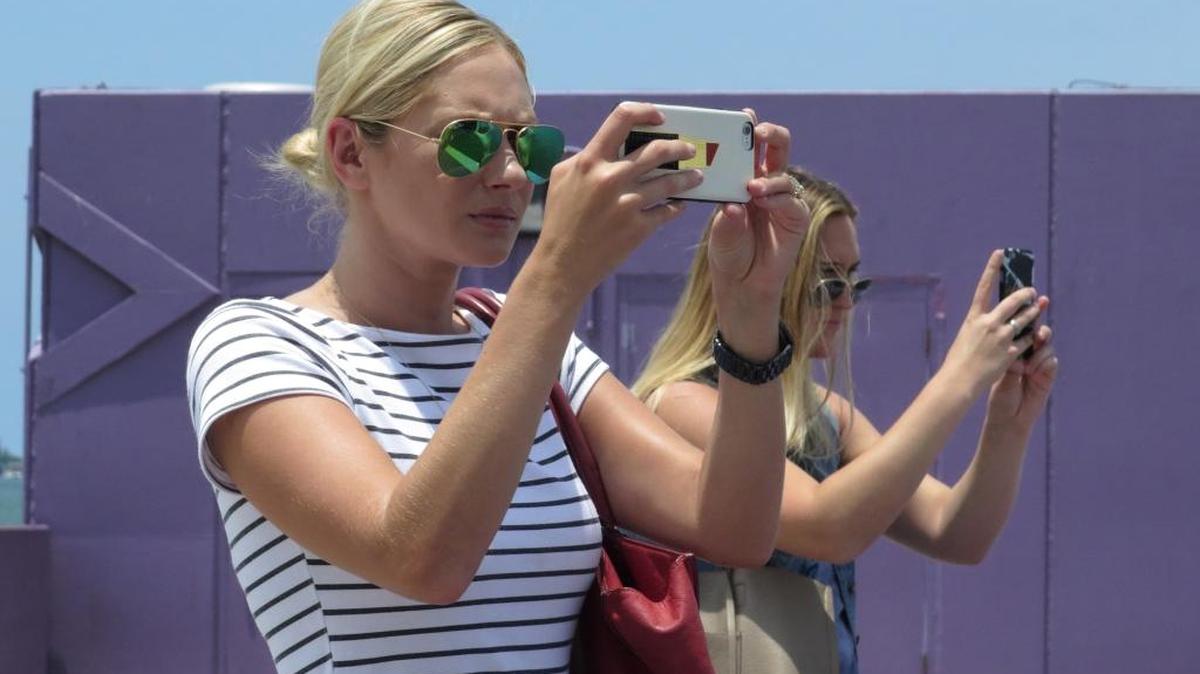 Alicia King and Elizabeth Knight, both public relations specialists with Three Six Oh PR, spend some time away from the office photographing for a client at the Sarasota waterfront. Both spend at least one day a week telecommuting to work.