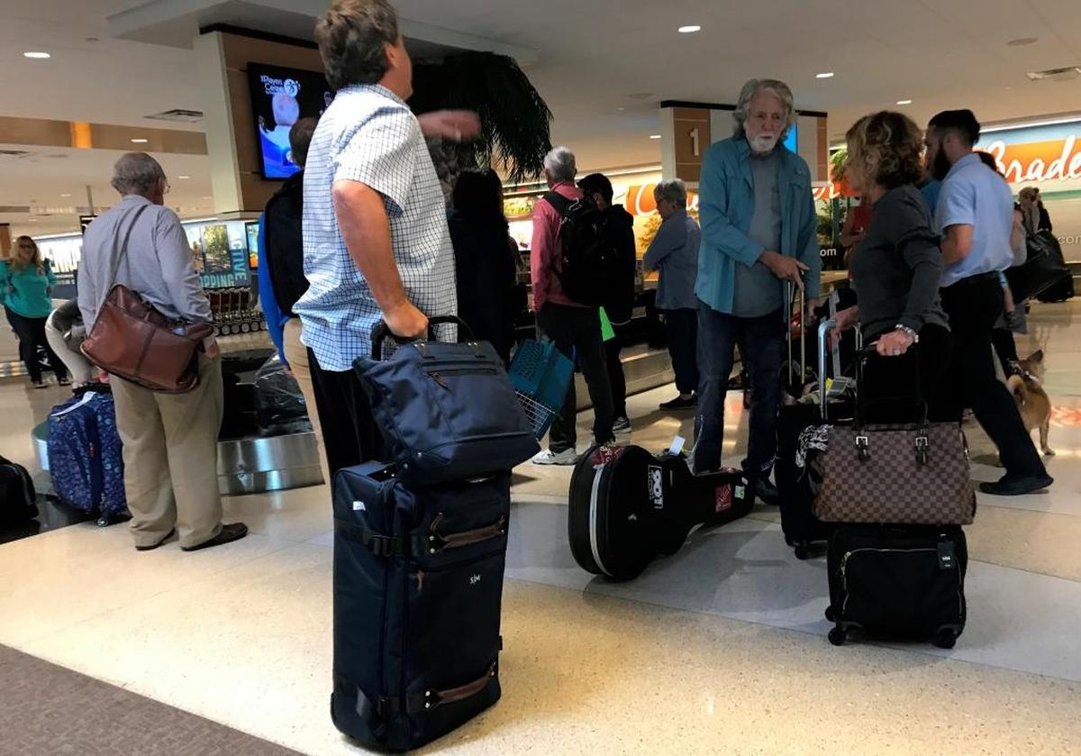 Passengers from Delta flight 2298 claim their baggage at Sarasota Bradenton International Airport on Tuesday morning.