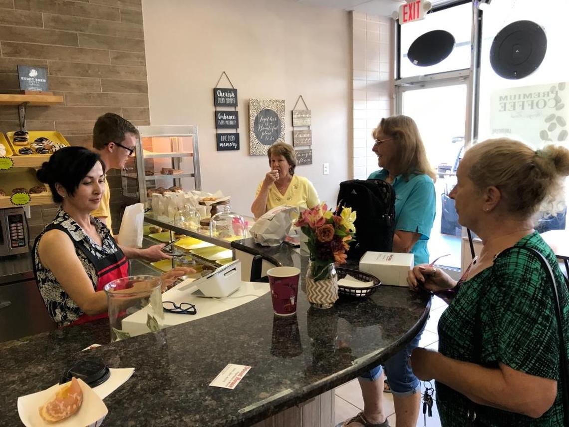 Janet Orr, in yellow, CC Keller and Mary Cihlar stopped by Donut House Espresso & More for fresh-made pastry on Tuesday.