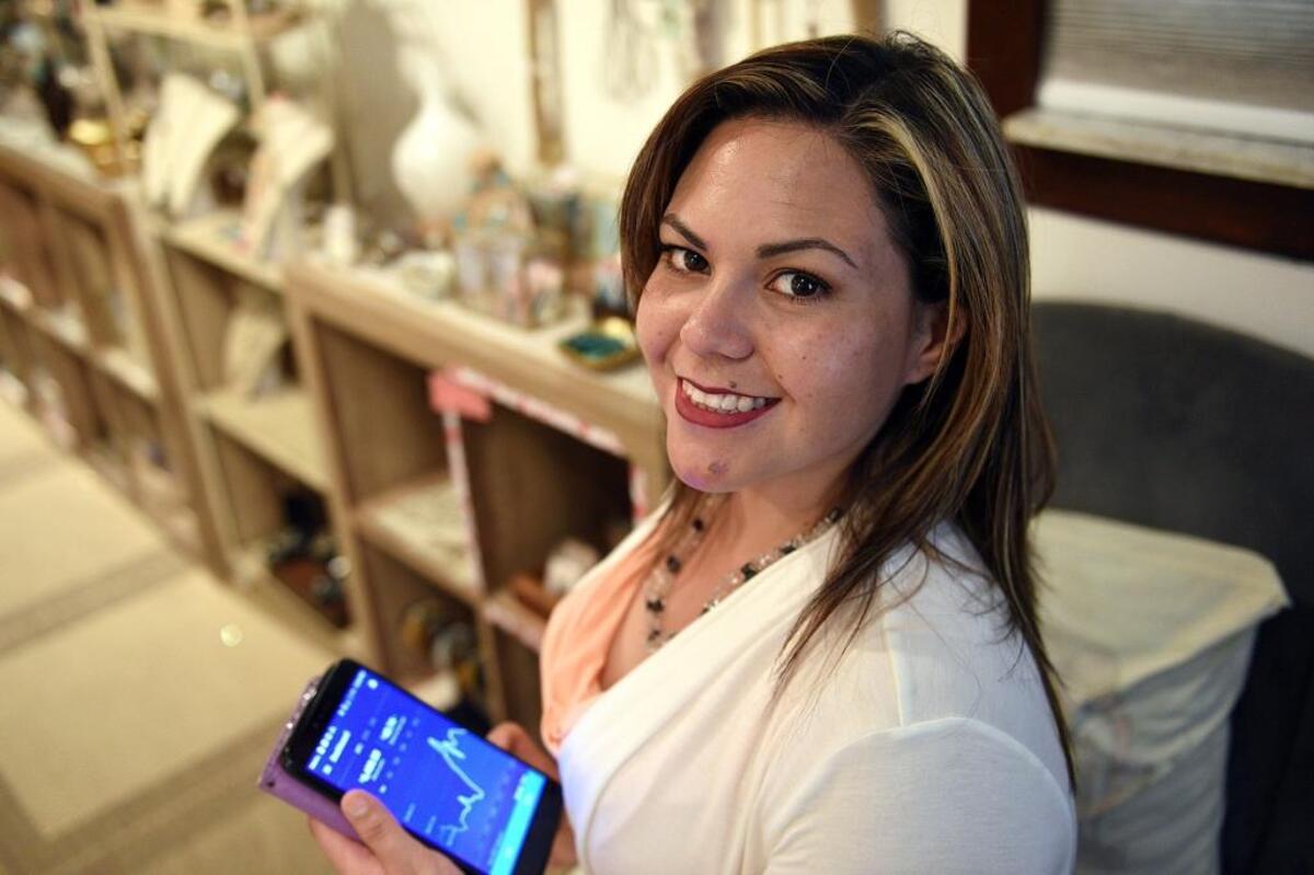 Laura Alcover, owner of Alcover Massage in Bradenton’s Village of the Arts, uses the digital currency bitcoin at her business.