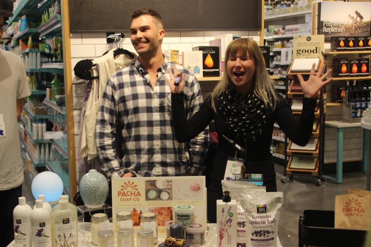 Whole Foods Market associates Blake Tigner and Dayleane Babyak show their enthusiasm for the company’s health and grooming products during a tour of the store this week.