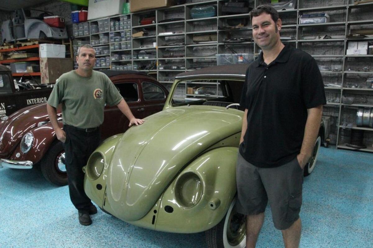 Jimmy Pollock, left, and Kip Zimmerman stand next to Zimmerman’s Beetle convertible that he has owned since high school.