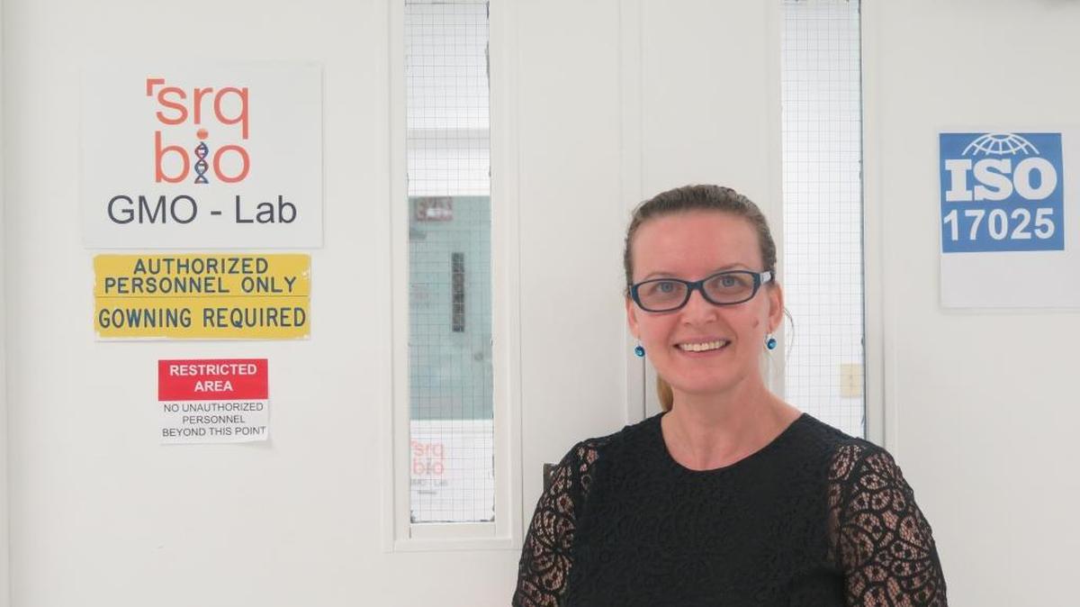 Ghania Ait-Ghezala, SRQ Bio’s technical director for GMO testing stands in front of SRQ Bio’s GMO-testing lab, which is certified under an international standard to conduct the tests.
