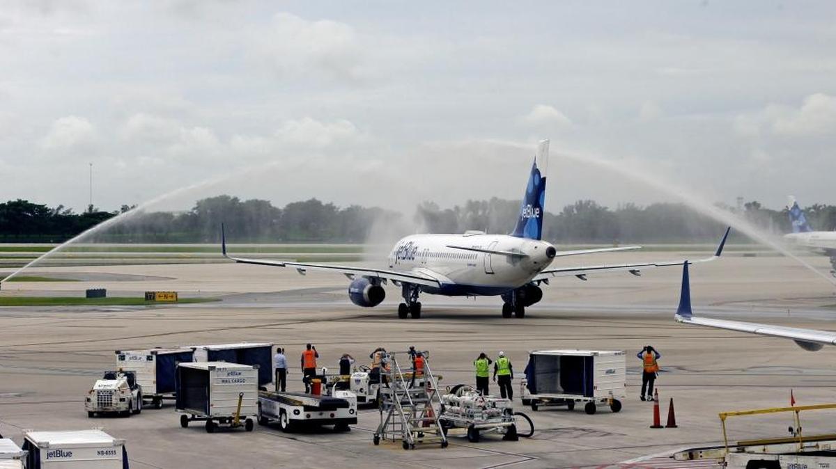 A water canon salute is given to JetBlue flight 387 at Fort Lauderdale-Hollywood International Airport before taking off for Santa Clara, Cuba, on Wednesday.