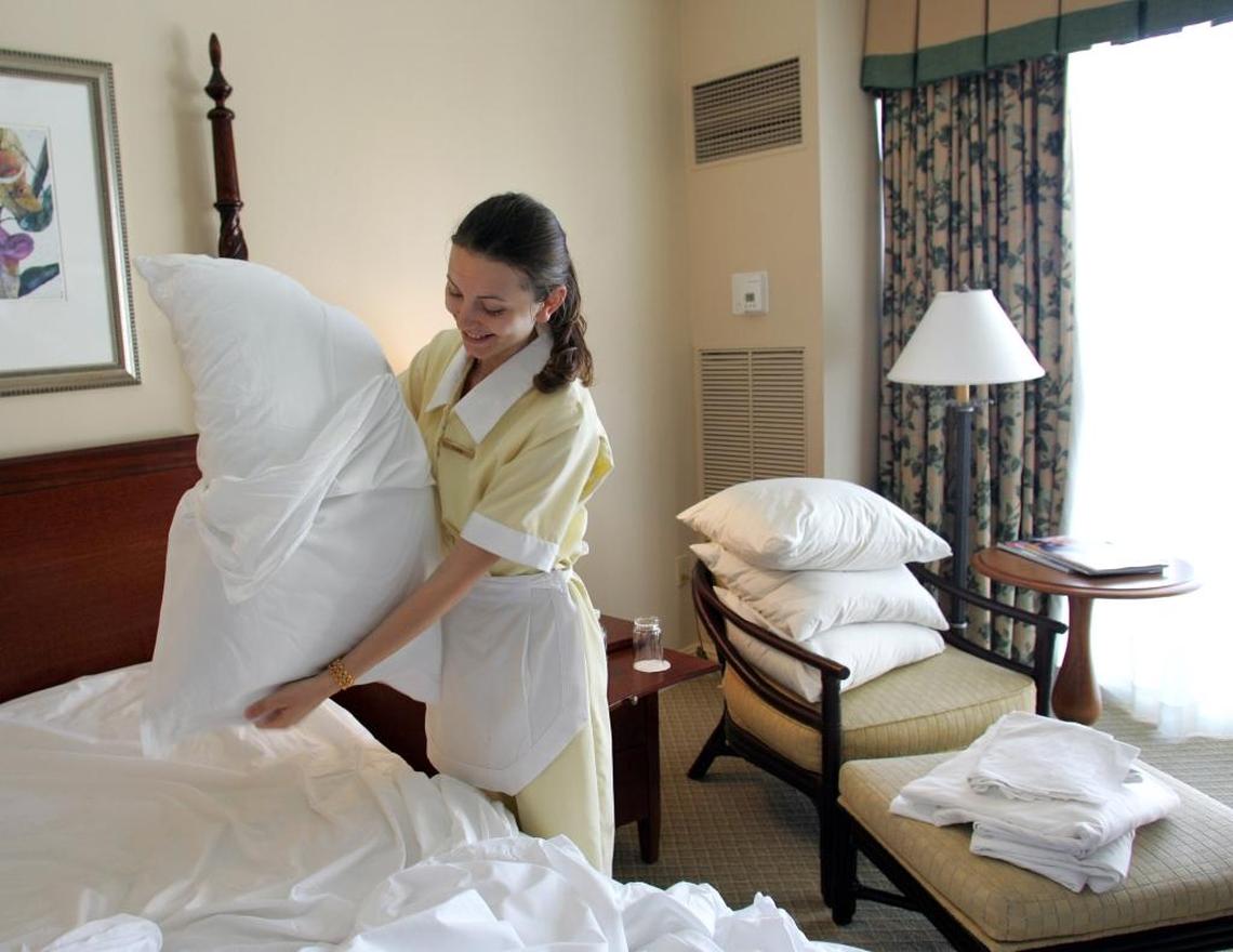 Elena Sofia Tinis changes the sheets in a room at the Ritz-Carlton Key Biscayne in 2006. Thousands of hospitality workers have lost jobs or suffered reduced hours amid the pandemic.
