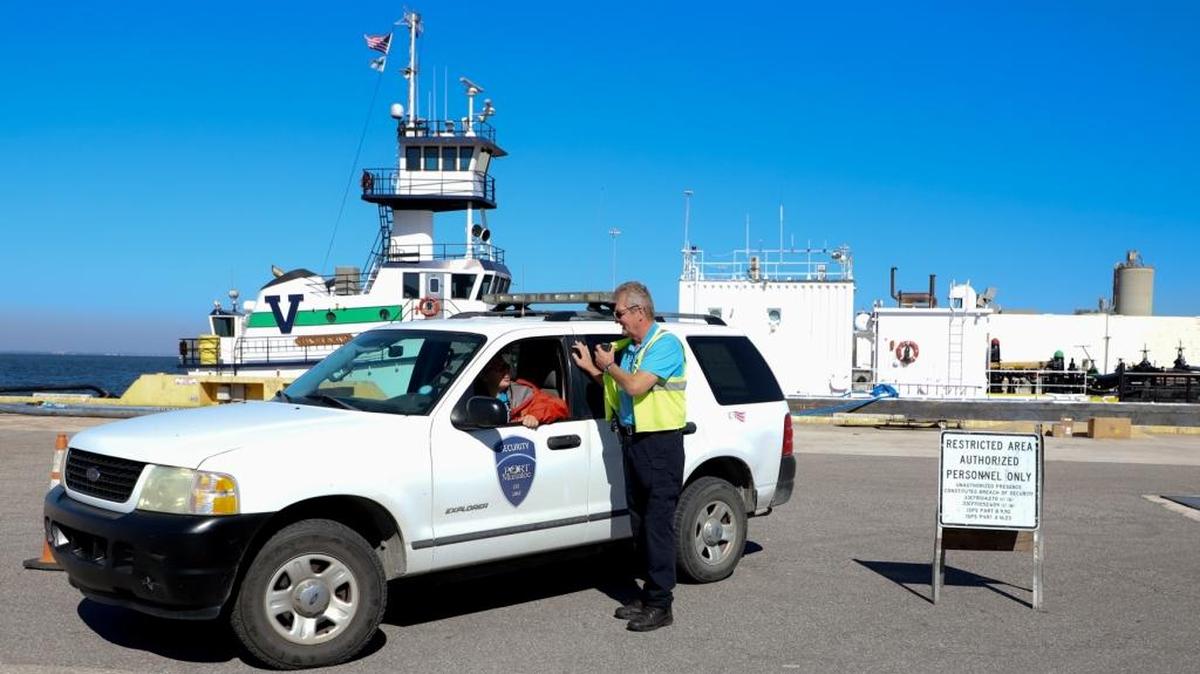 Port Manatee security officers Brandy Lewis (in vehicle) and Jack Tunney enforce access control for vessel operations.