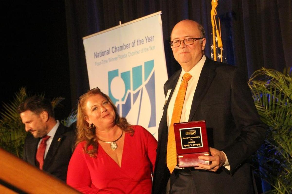 Clifford J. Walters accepted the Inaugural Robert P. Bartz Award for Outstanding Leadership before a crowd of 580, what he called “The house that Bob built.” Also shown are 2018 Chamber Chair Darcie Duncan and Jonathan Fleece, who presented the award.