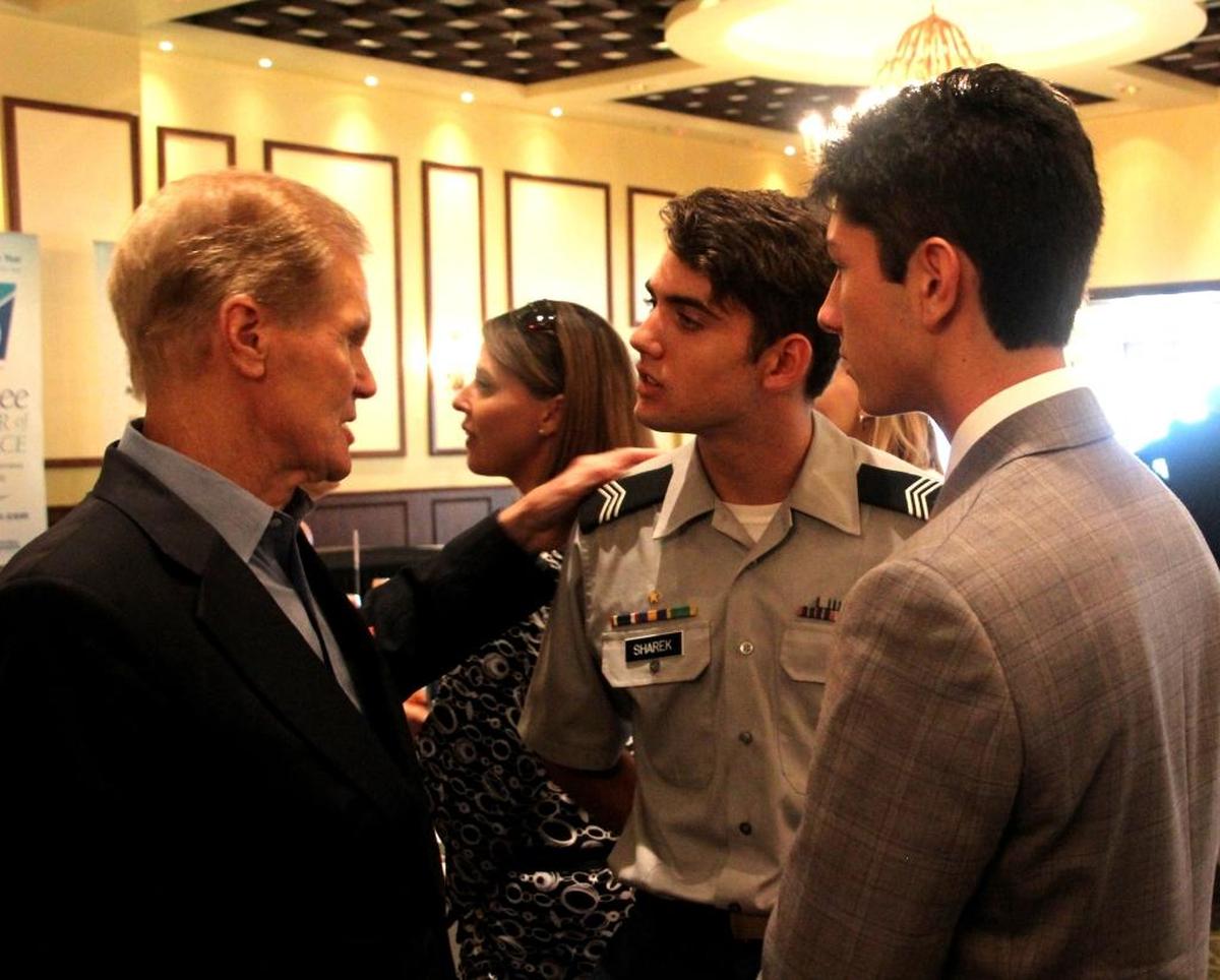 Senator Bill Nelson spent time talking to two high school students who attended the Manatee Chamber of Commerce luncheon on Monday. At center is Zach Sharek and at right is Logan Jeffries.