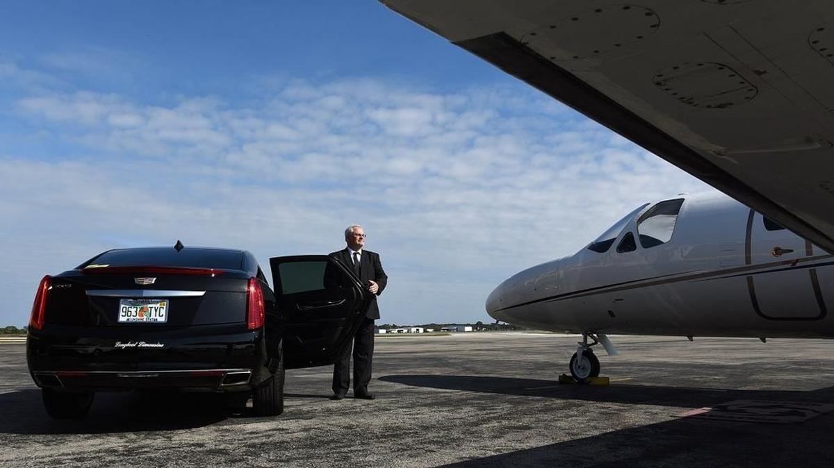 Jimmy Seaton, owner of Longboat Limousine, stands with of the the cars in his fleet at Dolphin Aviation. General aviation traffic at Sarasota Bradenton International Airport dropped after the recession and hasn't fully recovered since.