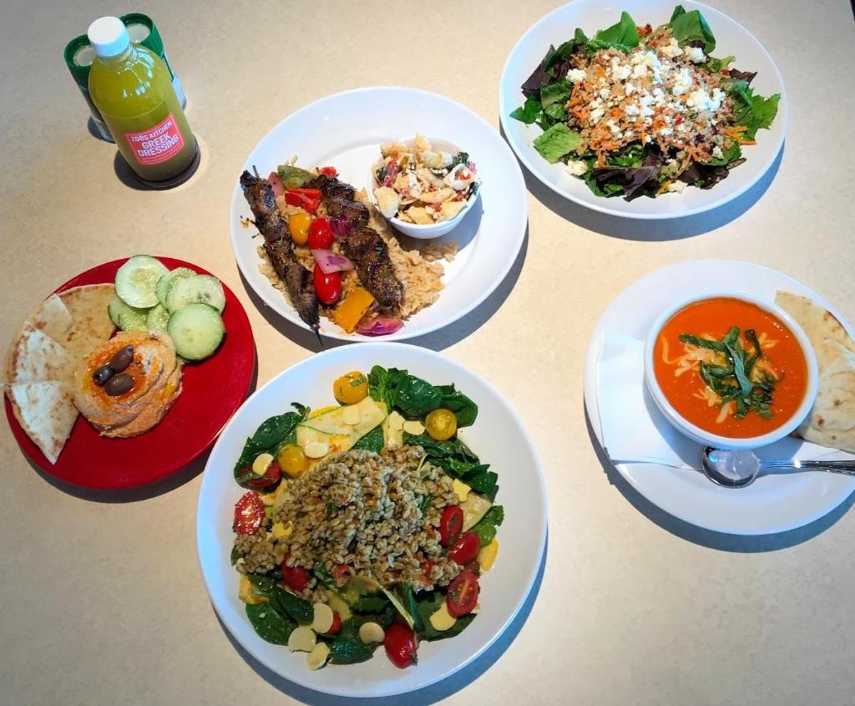 A sampling of offerings from Zoes Kitchen include, clockwise from right, Tomato Bisque Soup, Live Med Salad, Hummus and Salad Plate, Steak Kabobs, and Quinoa Salad.