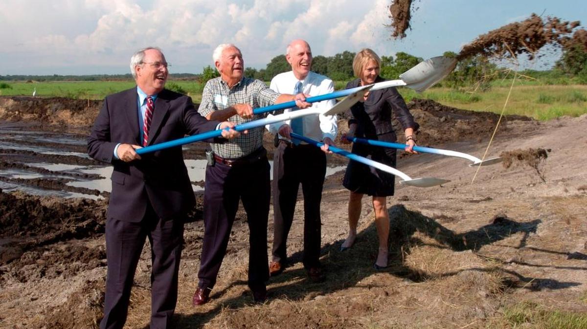 In 2010, Pat Neal with Neal Communities, Fred Derr with Derr and Company, Mark Sochar and Leisa Weintraub both with Neal Communities, shovel dirt into the air during a ground breaking ceremony at the site of Central Park at Lakewood Ranch.