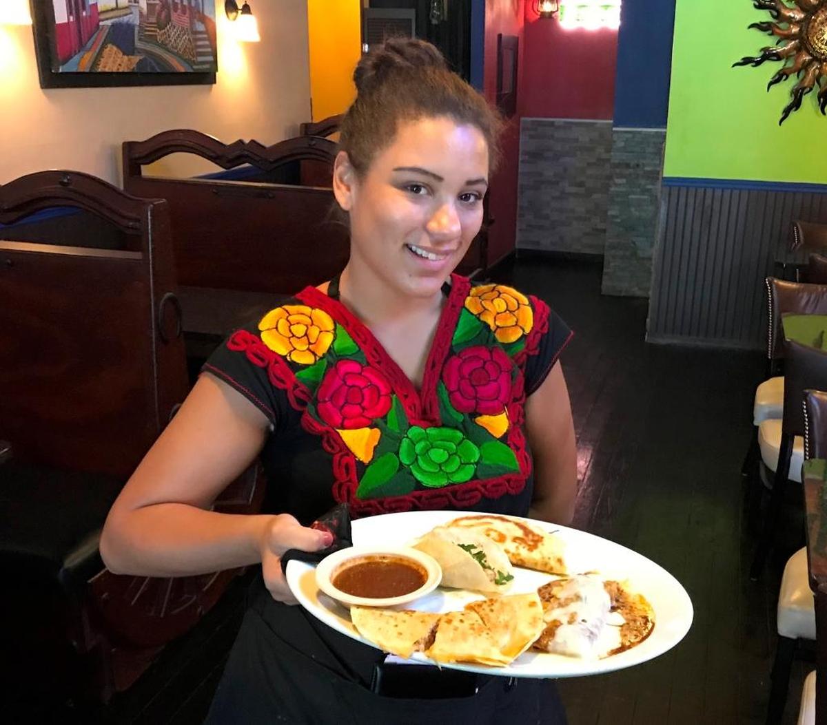 Coco Robinson presents a platter of Tacos Michoacanos, enchiladas, quesadillas, hot sauce and street tacos at Señor Fajitas, a new Mexican grill at 316 Old Main Street in downtown Bradenton.