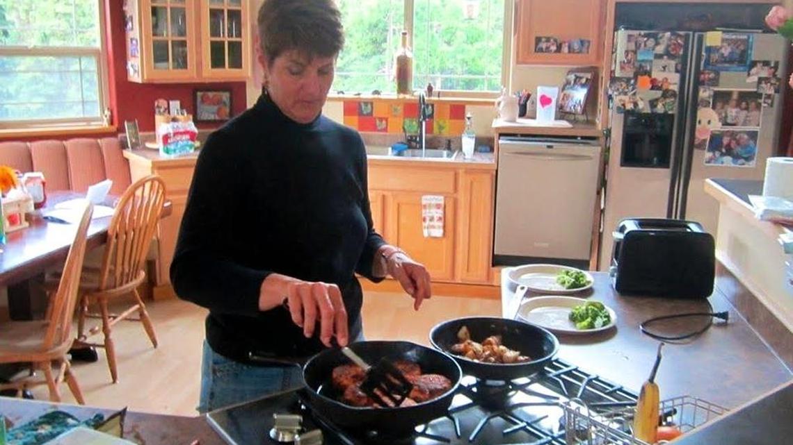 Jeannine Germer cooks dinner salmon cakes in a home exchange in Anchorage, Alaska.