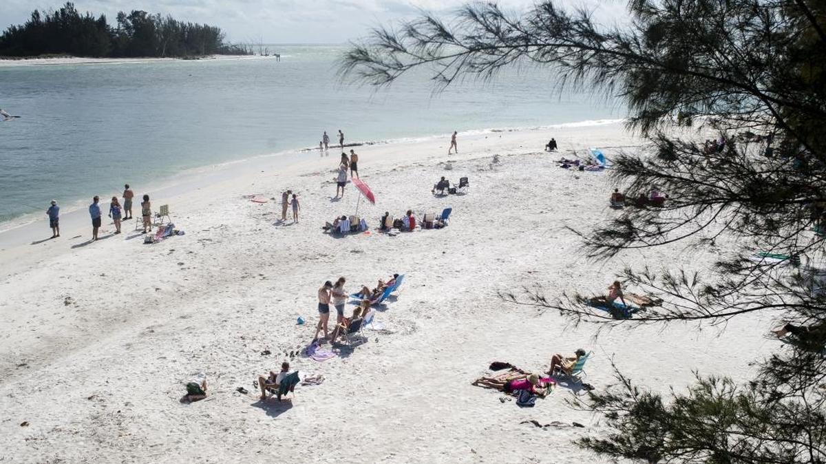 Beachgoers soak up the sun on Tuesday afternoon at Bradenton Beach on Anna Maria Island.