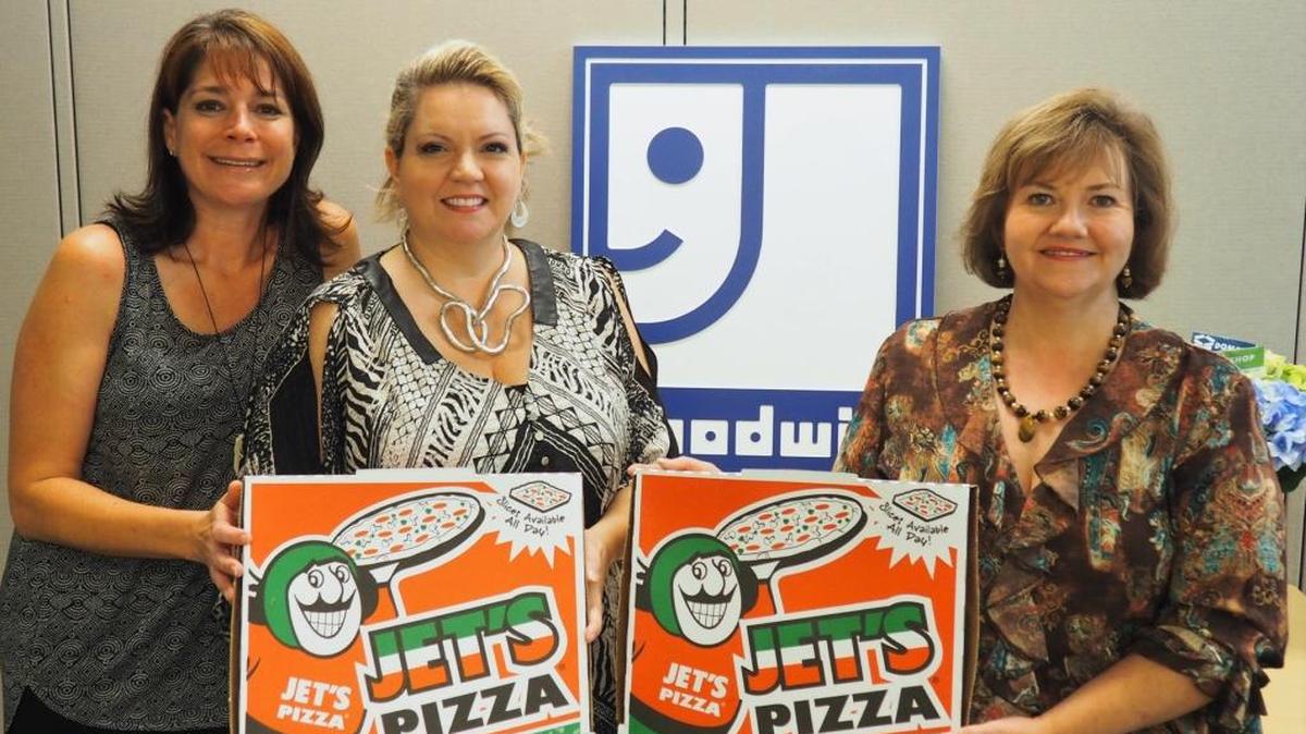 From left, Goodwill Manasota Director of Marketing and Public Relations Samantha Cummins, Goodwill Manasota Vice President Veronica Brandon Miller and Goodwill Manasota Director of Development Morgan Gerhart prepare to launch the October bounce-back program with Jet’s Pizza.