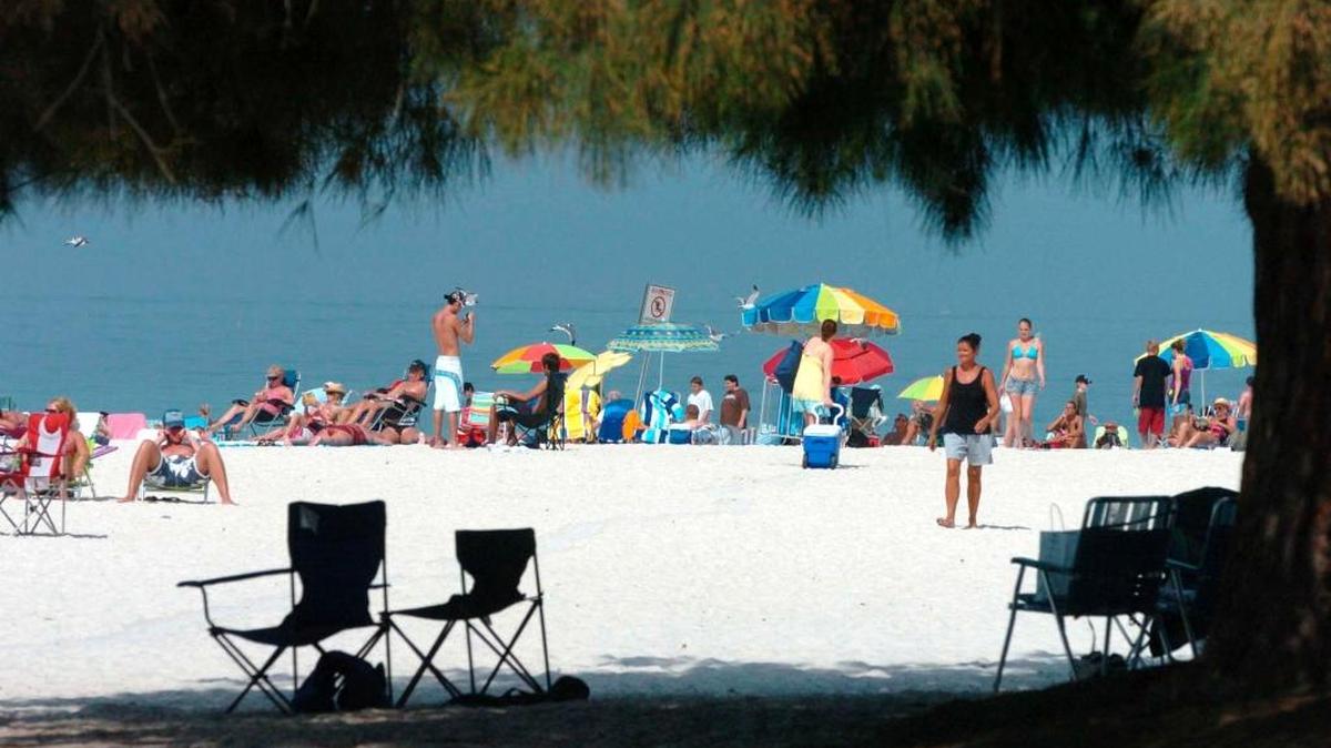 People enjoy the sun and shade at the Manatee Public Beach. Tourism continues to grow in Manatee County, despite market uncertainty before, during and after the 2016 presidential election.