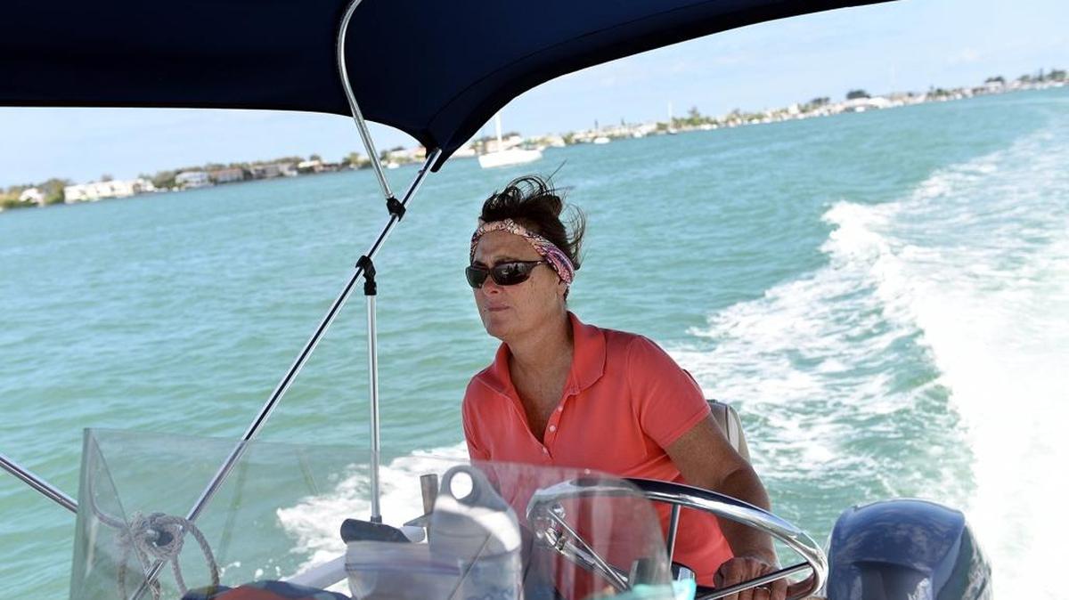 Capt. Kathe Fannon drives her boat through the waters just off the shoreline from lush mangroves and bird nesting sites.