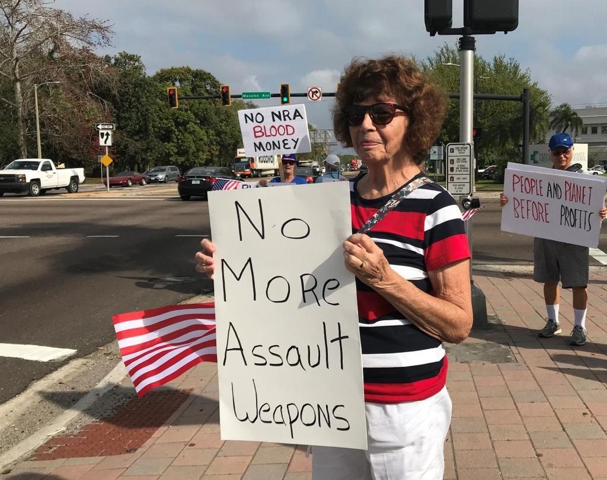 Thea Kelley held a sign Tuesday that demanded “no more assault weapons.” She was with a group of Indivisible Bradenton demonstrators who stood at U.S. 301 and Manatee Avenue.