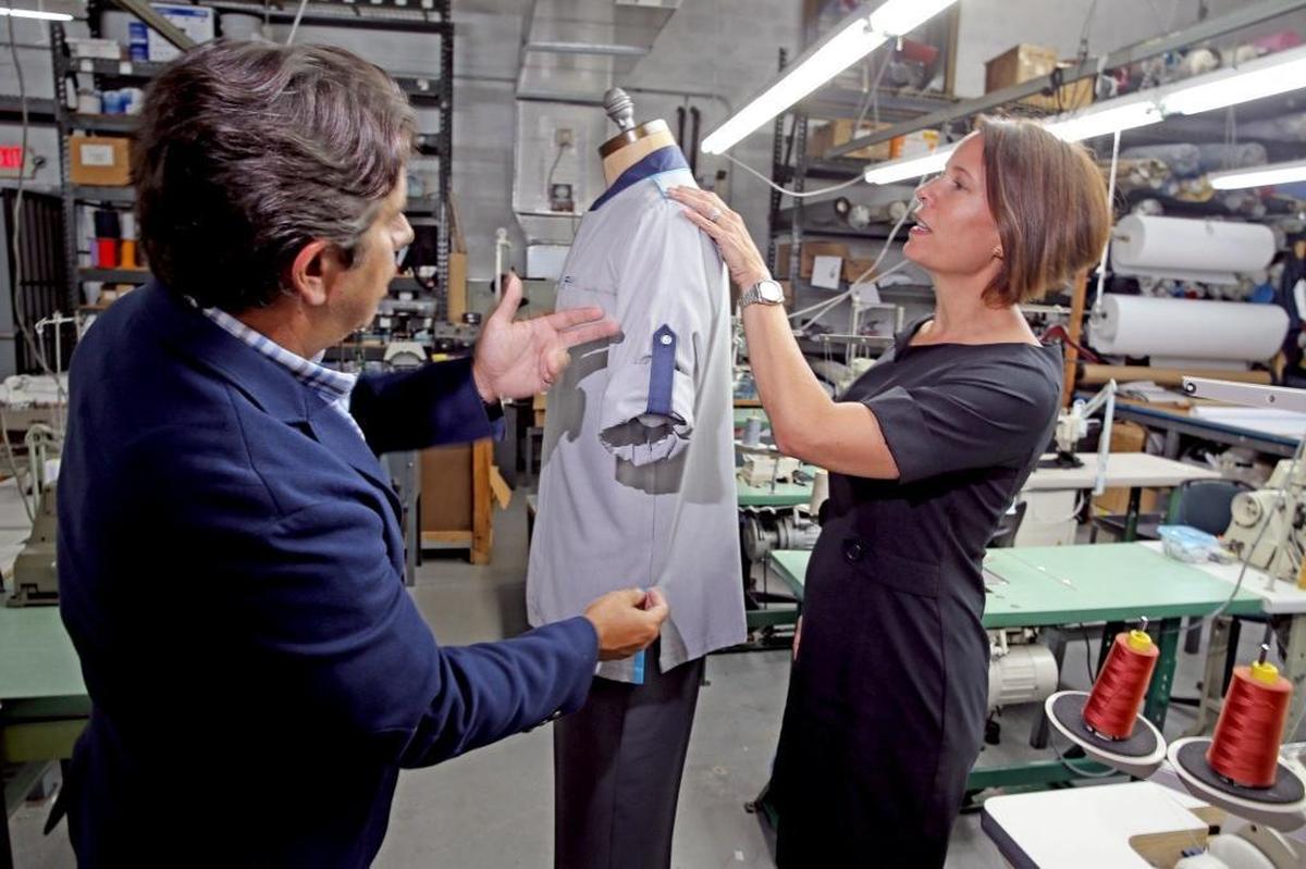 Alex Arencibia and Menchu Dominicis inspect merchandise at their family business, J.A. Uniforms in West Kendall.