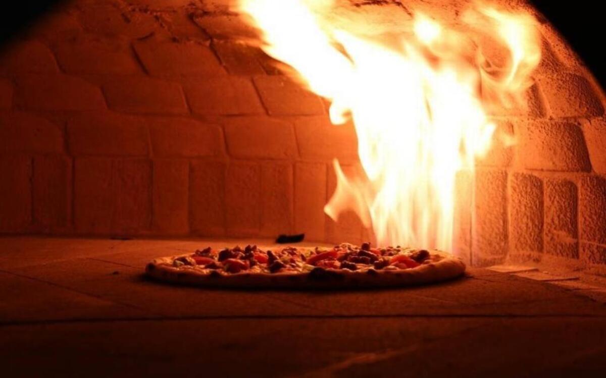 Each pizza is cooked in a custom-built Neapolitan oven that reaches 1,000 degrees and is ready in about 2 minutes.