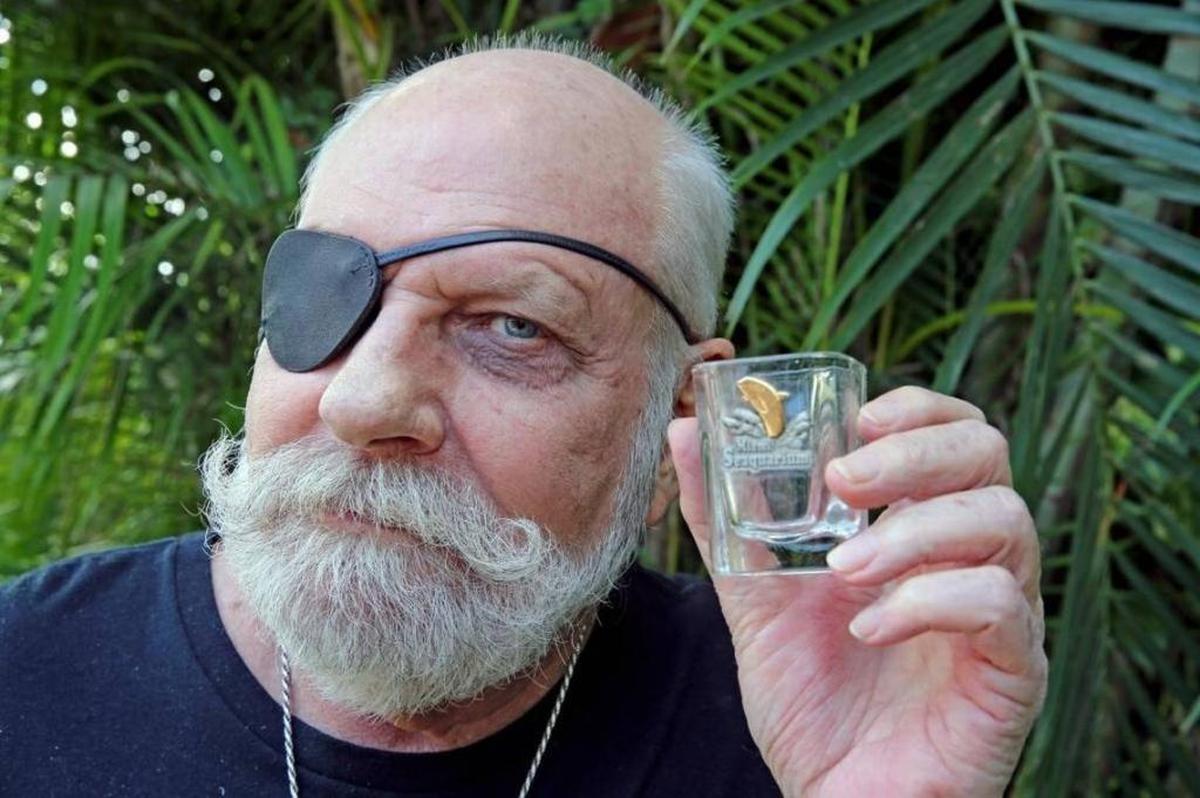 Animal activist Russ Rector holds a Miami Seaquarium shot glass at his Fort Lauderdale home on Nov. 2, 2017. Rector believes moving Lolita, an orca who has lived most of her 50 years alone in an arguably small tank at the Miami Seaquarium, would face a number of hurdles to be successfully transferred to a netted, seaside sanctuary near her original home by Puget Sound.
