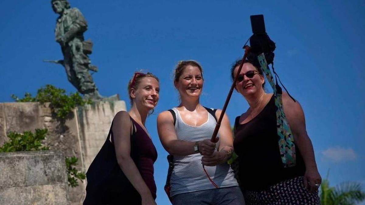 Tourists take a selfie by the statue of revolutionary hero Ernesto “Che”Guevara in Santa Clara, Cuba. American travelers have begun to explore destinations outside Havana.