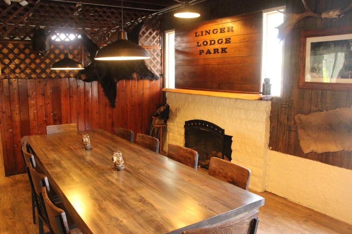 The Linger Lodge sign was already there, but was covered by a huge alligator before renovations at Linger Lodge. The community table shown above is another new feature of the East Manatee landmark.
