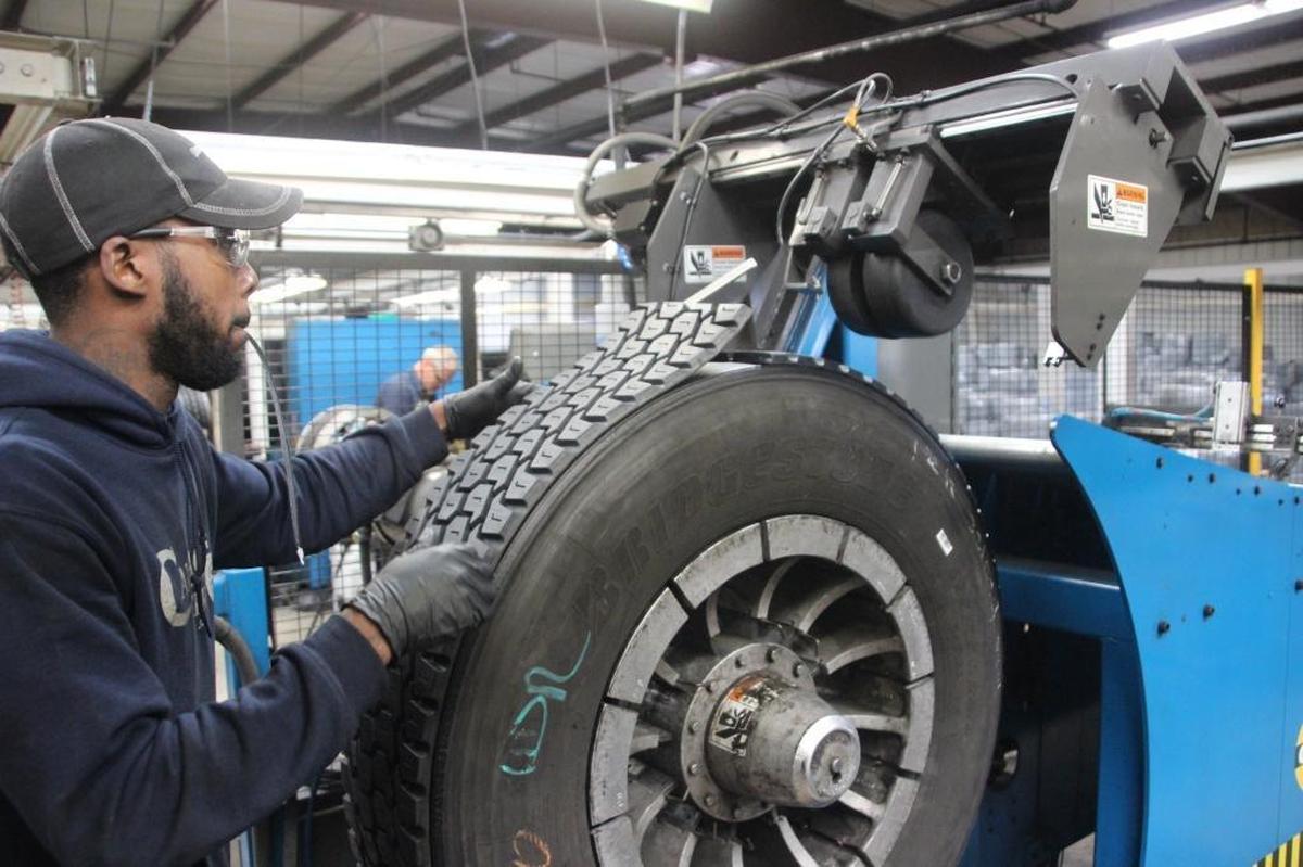 Jeremy Taylor applies new tread to a tire at Callaghan Tire. The company has two Bandag retread plants, an industrial tire repair facility, a full service auto center, and Callaghan Industrial Tire, which is dedicated to forklift and industrial tire service.