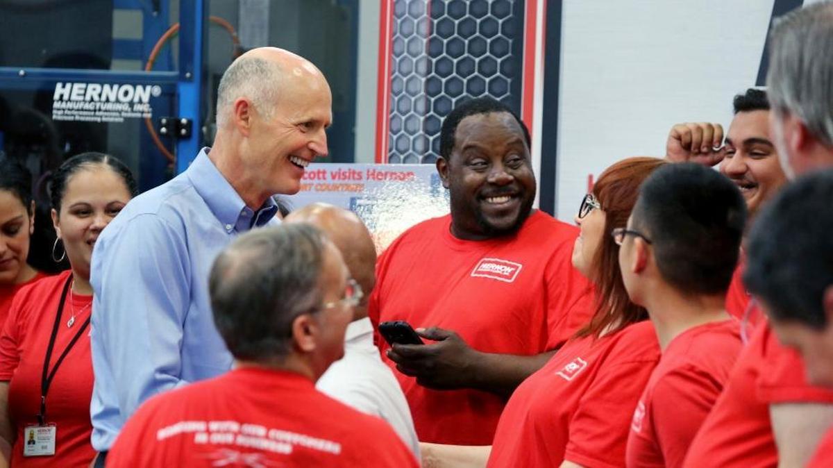 Florida Gov. Rick Scott greets employees Monday at Hernon Manufacturing, a producer of industrial-use adhesives, during a stop to pitch his plan to cut $180 million in taxes and fees, in Sanford.