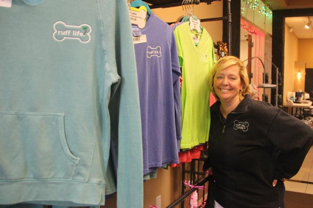 Julie Nickerson is shown with a display of her ruff life apparel at her store in the Jennings Arcade Mall on Bradenton’s Old Main Street.