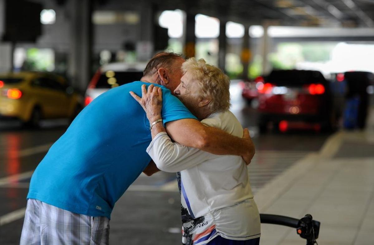 Rick Surette, left, who lives in Charlotte County, hugs mother-in-law Jacqulyn Umhoefer, 92, from Cape Coral, after Rick drove four hours to drop her off at Tampa International Airport ahead of the arrival of Hurricane Irma.