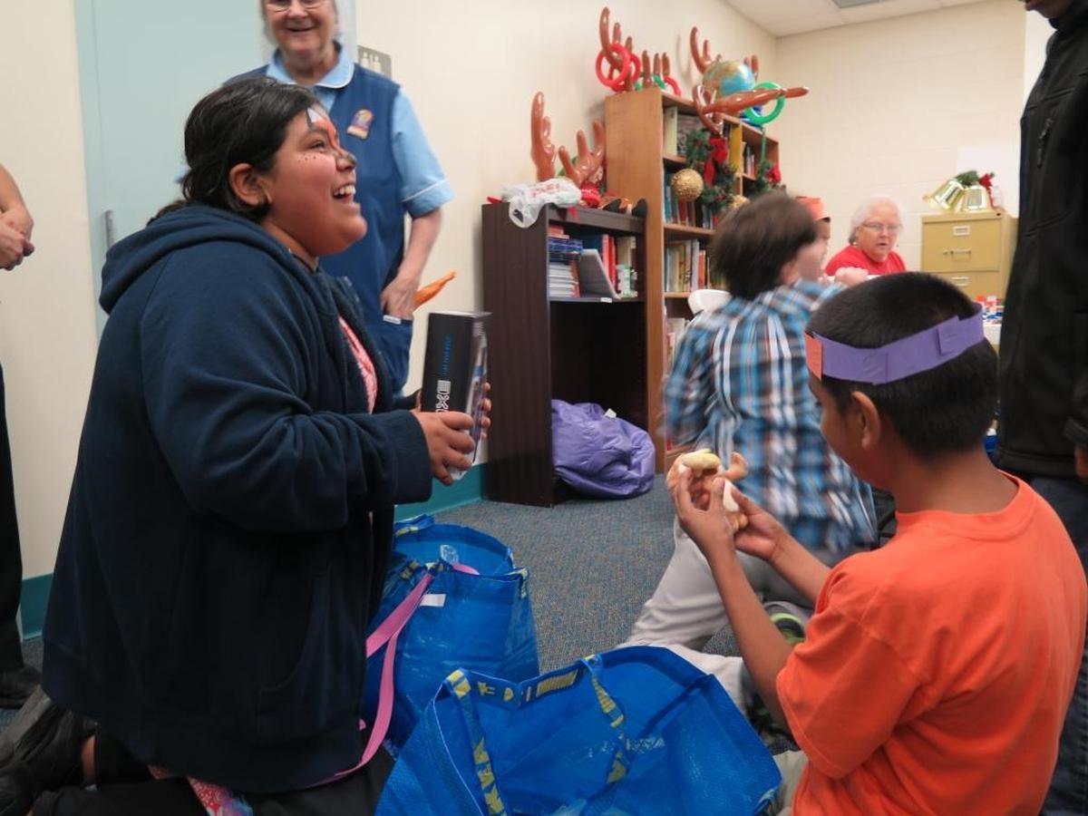 Students at McKay Academy in Bradenton show off their gifts from Santa Claus on Friday after a visit from the Flight to the North Pole program. It’s the first year the Flight to the North Pole has expanded outside the annual event at the Sarasota Bradenton International Airport Fire Department.