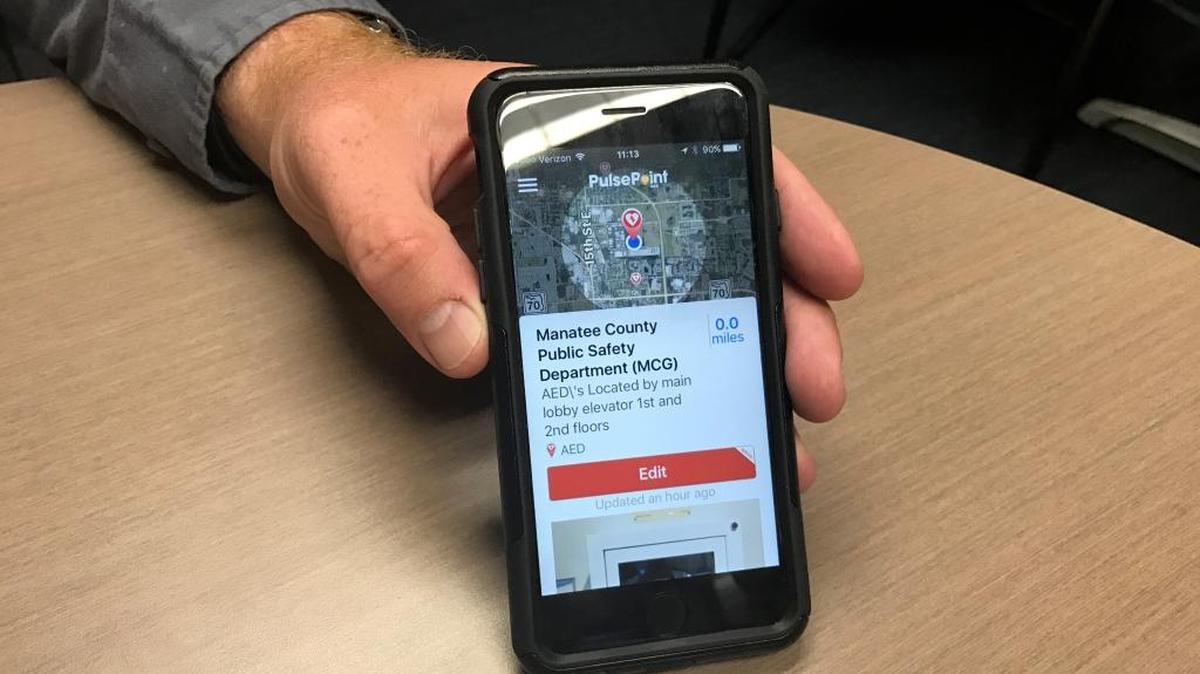 Jacob Saur, Chief of Emergency Communications 911 in Manatee County, shows what registering an AED on the PulsePoint app looks like. He hopes community members will register nearby AEDs to build the app’s local database.