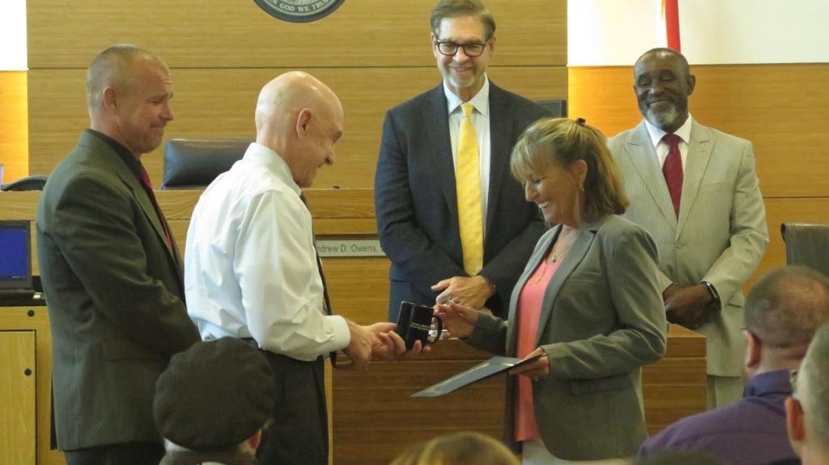 Lorelle Scott, center, receives a mug at the 19th Annual 12th Judicial Circuit Drug Court Program graduation at the Manatee County Judicial Center on May 26. Scott was one of three graduates at the 2016 graduation.