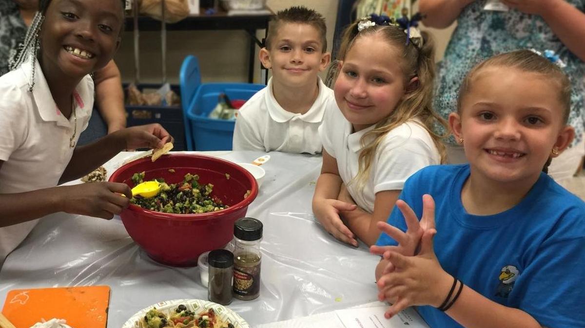 A group of children work together during a cooking lesson at the DeSoto Boys & Girls Club. A $500,000 donation from an anonymous benefactor will go toward the new Club's state-of-the-art culinary kitchen.